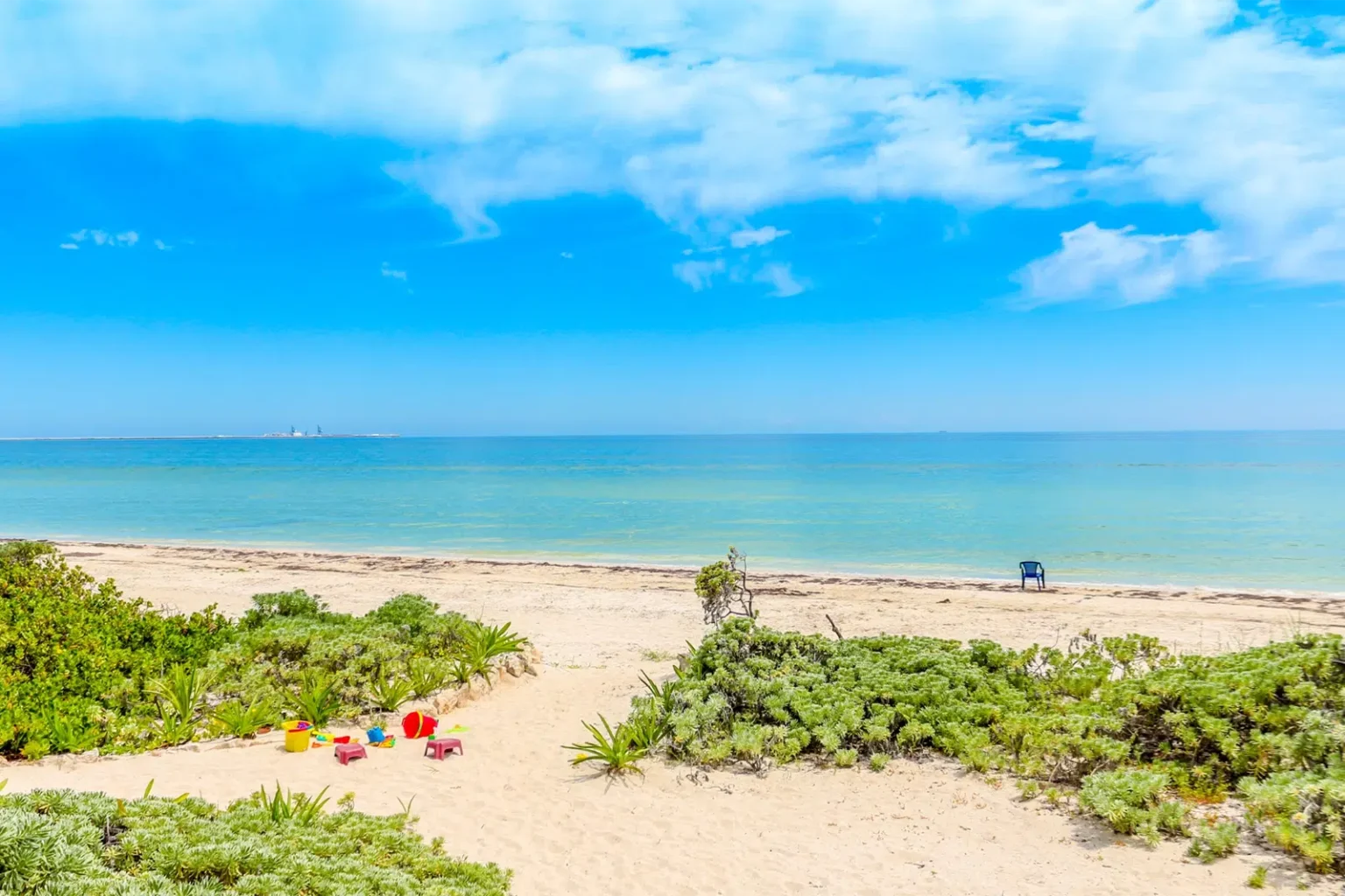 A beach with inviting, calm blue sea and sky - Business Consulting For NDIS Providers - NDIS Provider Marketing